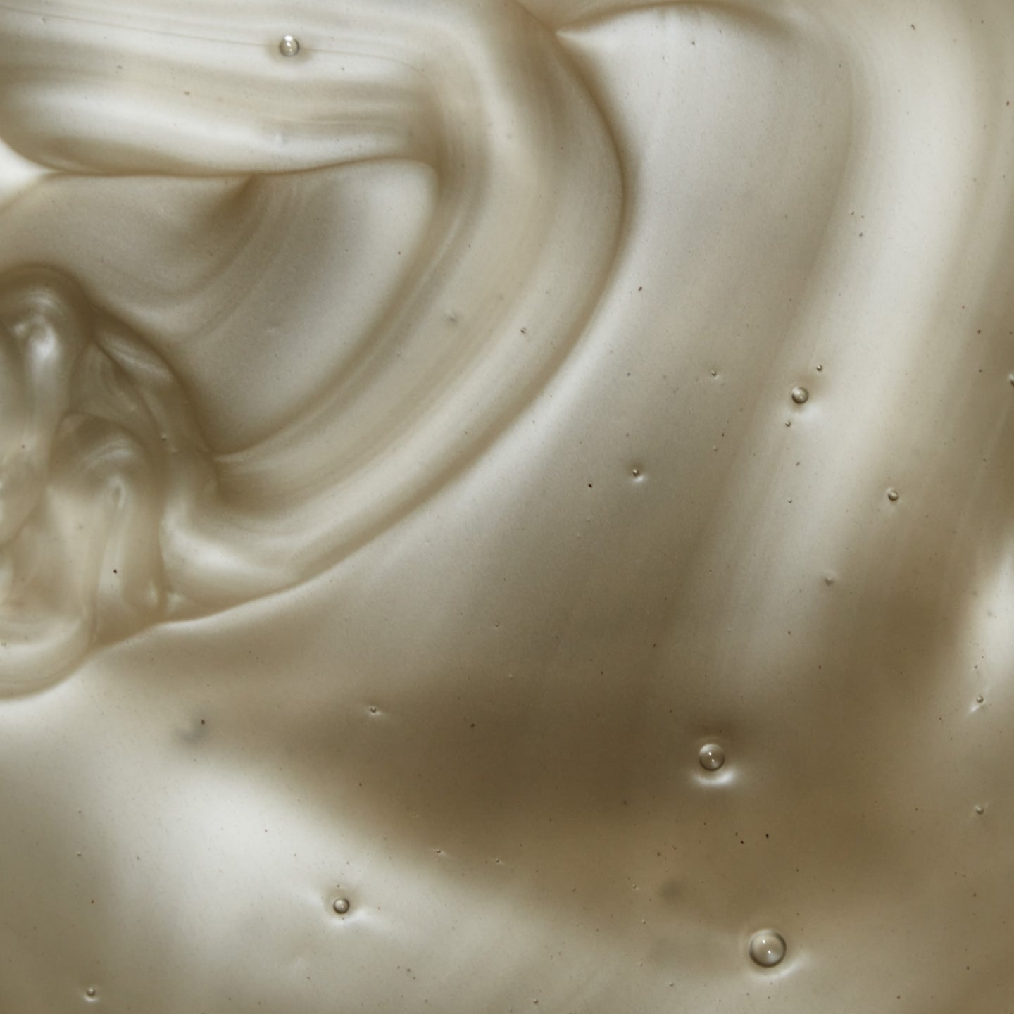 Close up of grey metallic dandruff shampoo swatch. 