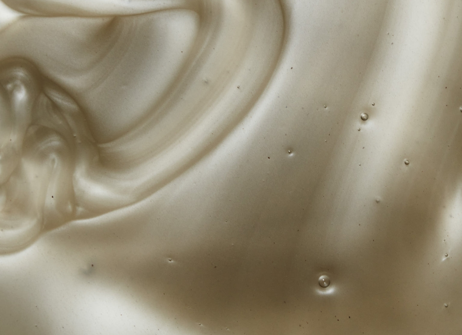 Close up of grey metallic dandruff shampoo swatch. 