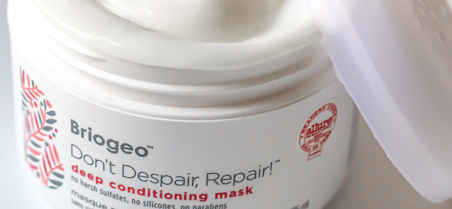 Open tub of Dont' Despair, Repair! Deep Conditioning Mask with lid resting on its side
